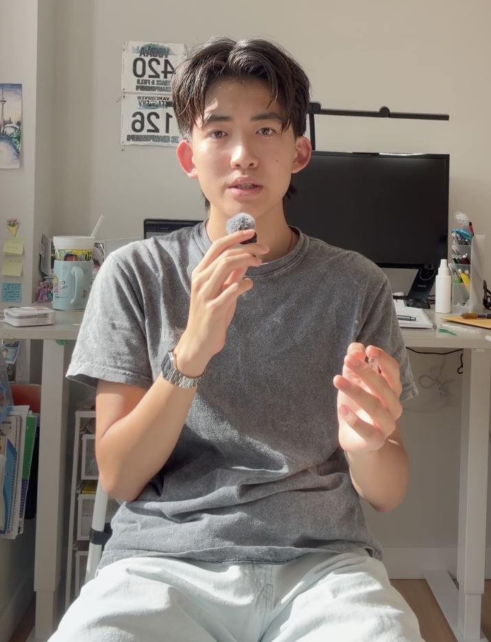 Johnson holding a microphone at his desk